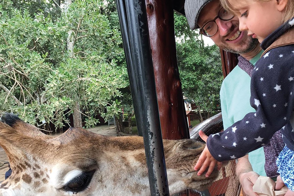 High time: Arne Kuehl and his daughter enjoying a close-up encounter with the local wildlife in Kenya.