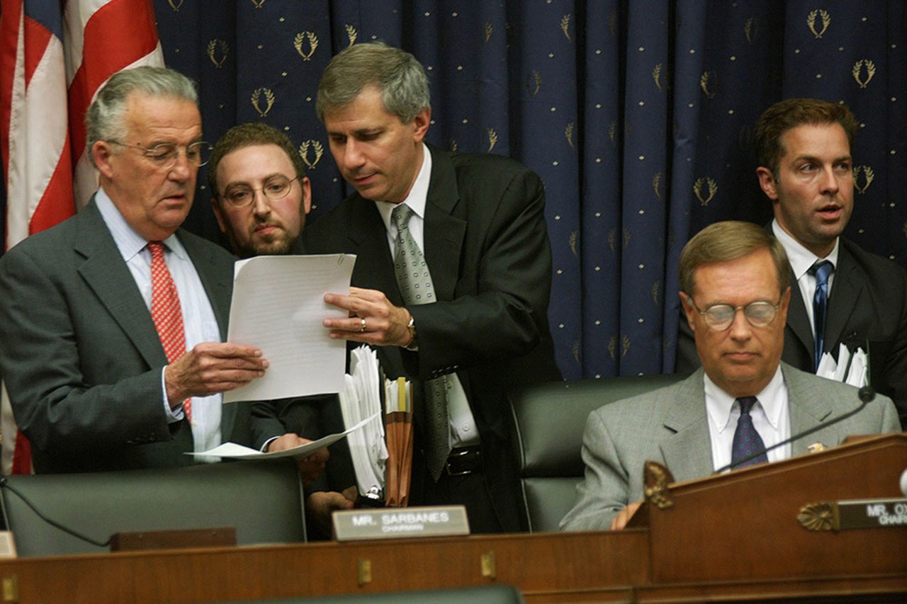 Paul Sarbanes, left, and Michael Oxley, seated, at the passing of the Sarbanes-Oxley Act in 2002