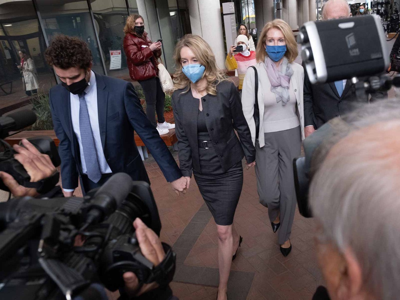 Elizabeth Holmes (centre), founder and former CEO of life sciences company Theranos, leaves court in January